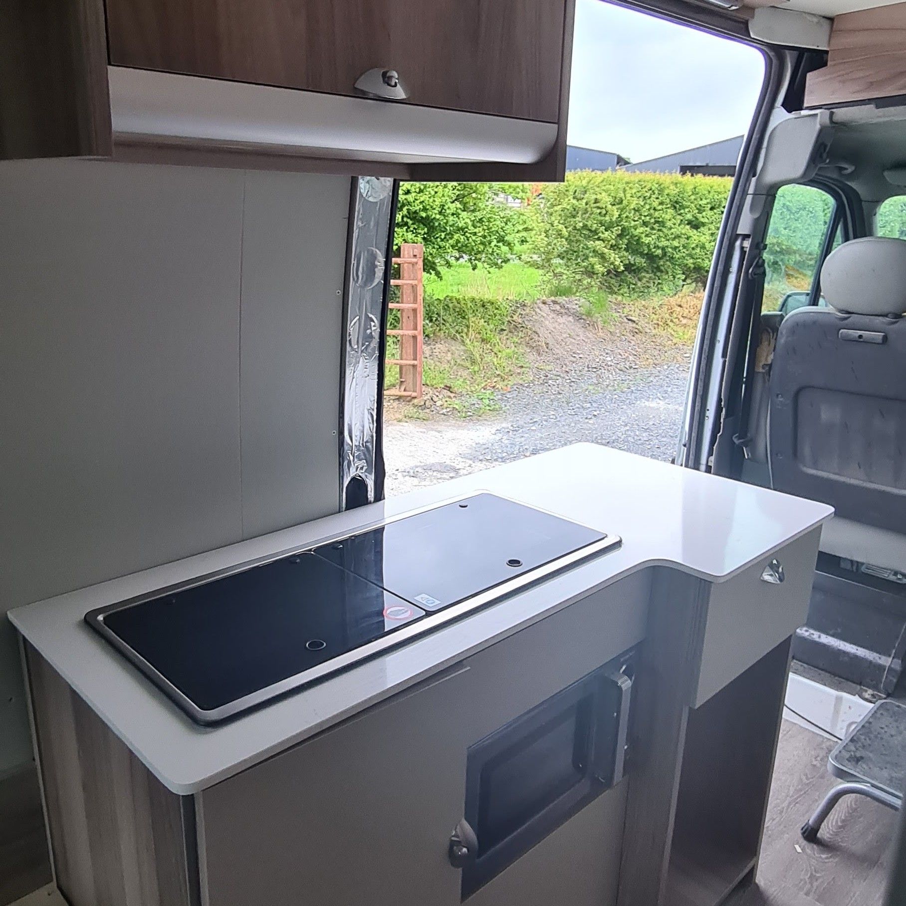 Worktop and hob with the sliding door open.